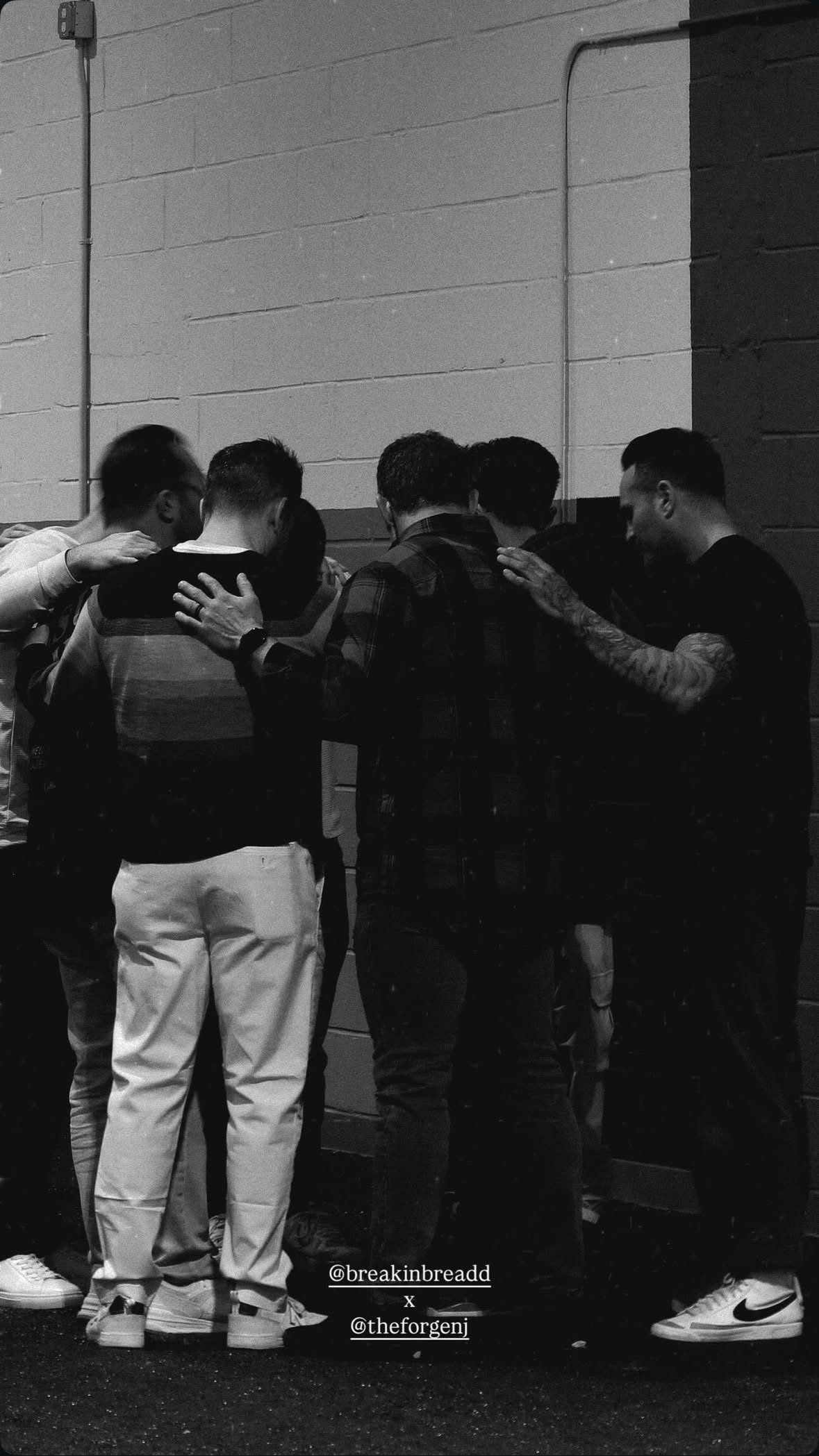 Men praying together at The Forge